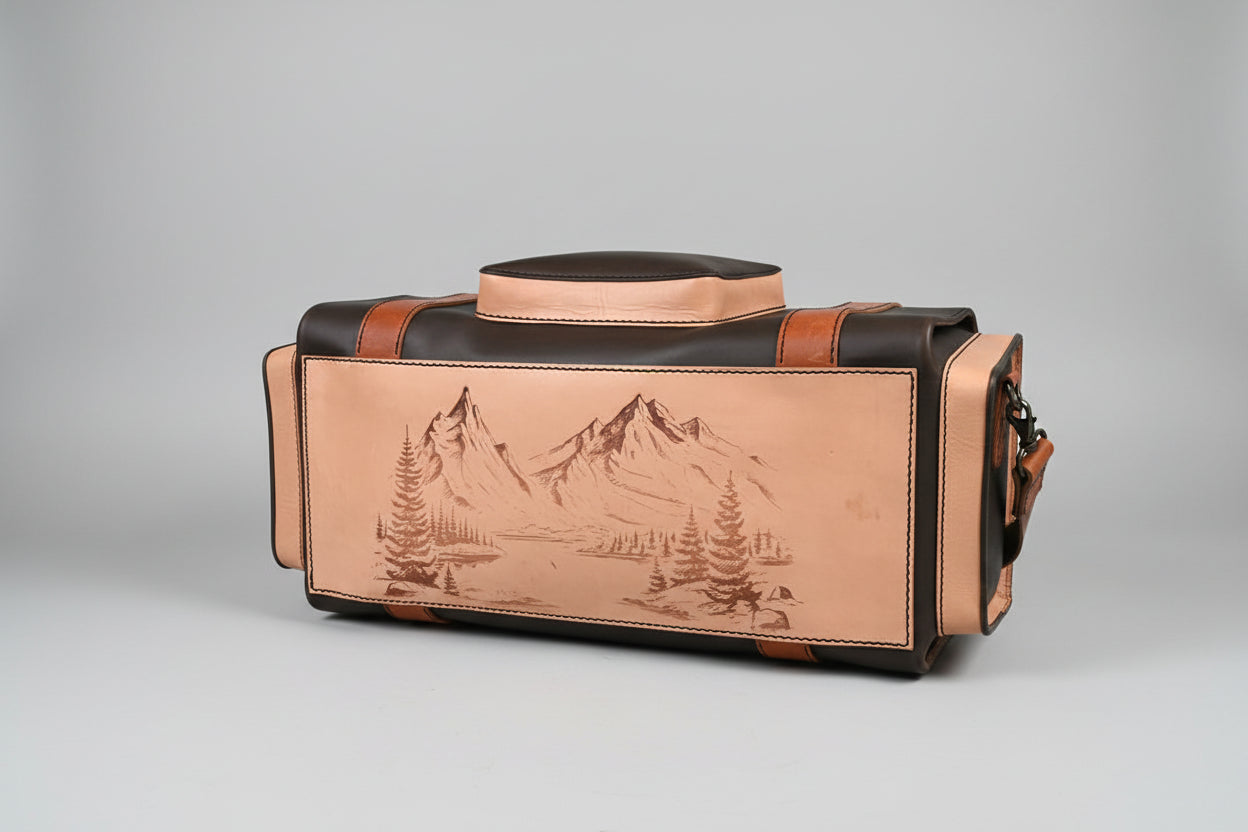 Leather bag with mountain design on a wooden surface