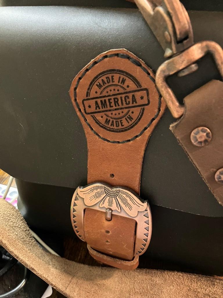 Leather strap with 'Made in America' stamp on a black bag