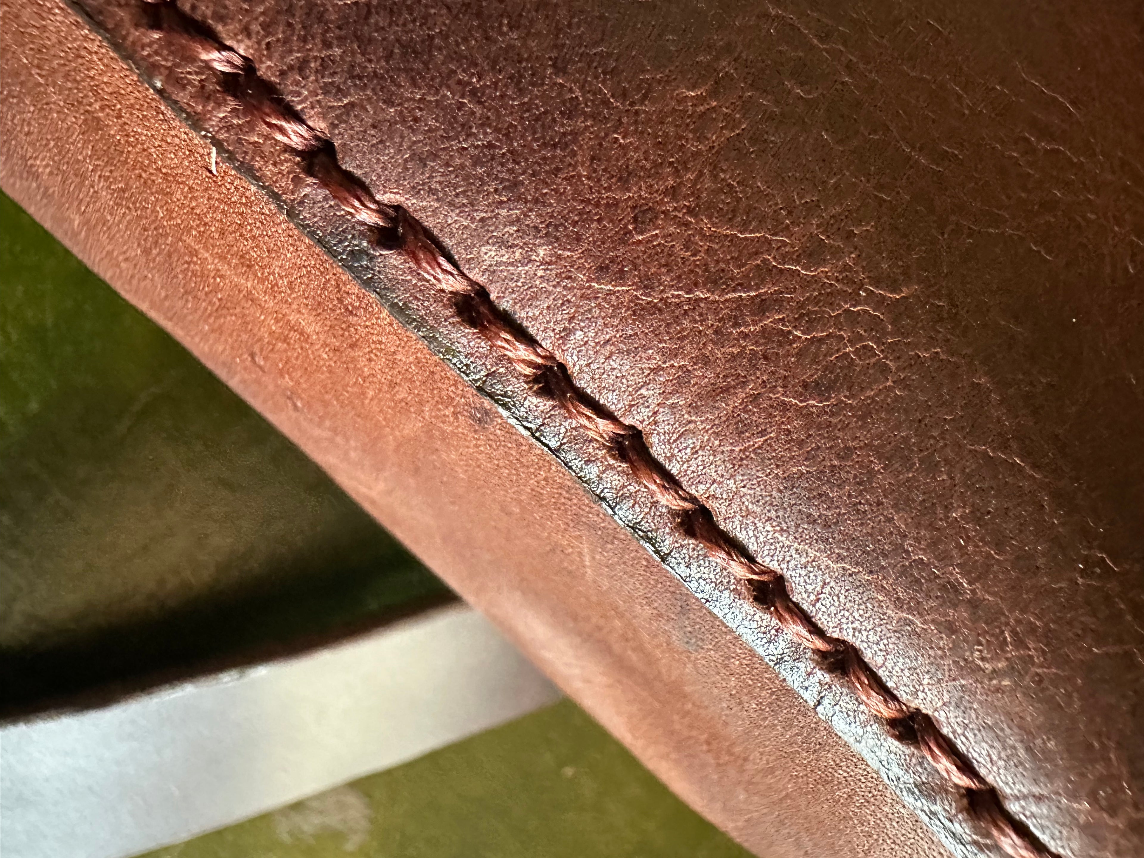 Close-up of brown leather with visible stitching