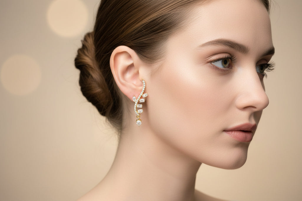 Gold and diamond earrings on a white stand.