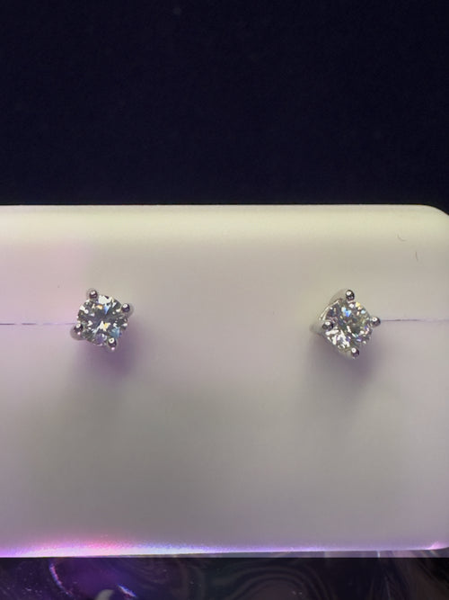 Pair of diamond stud earrings on a white background