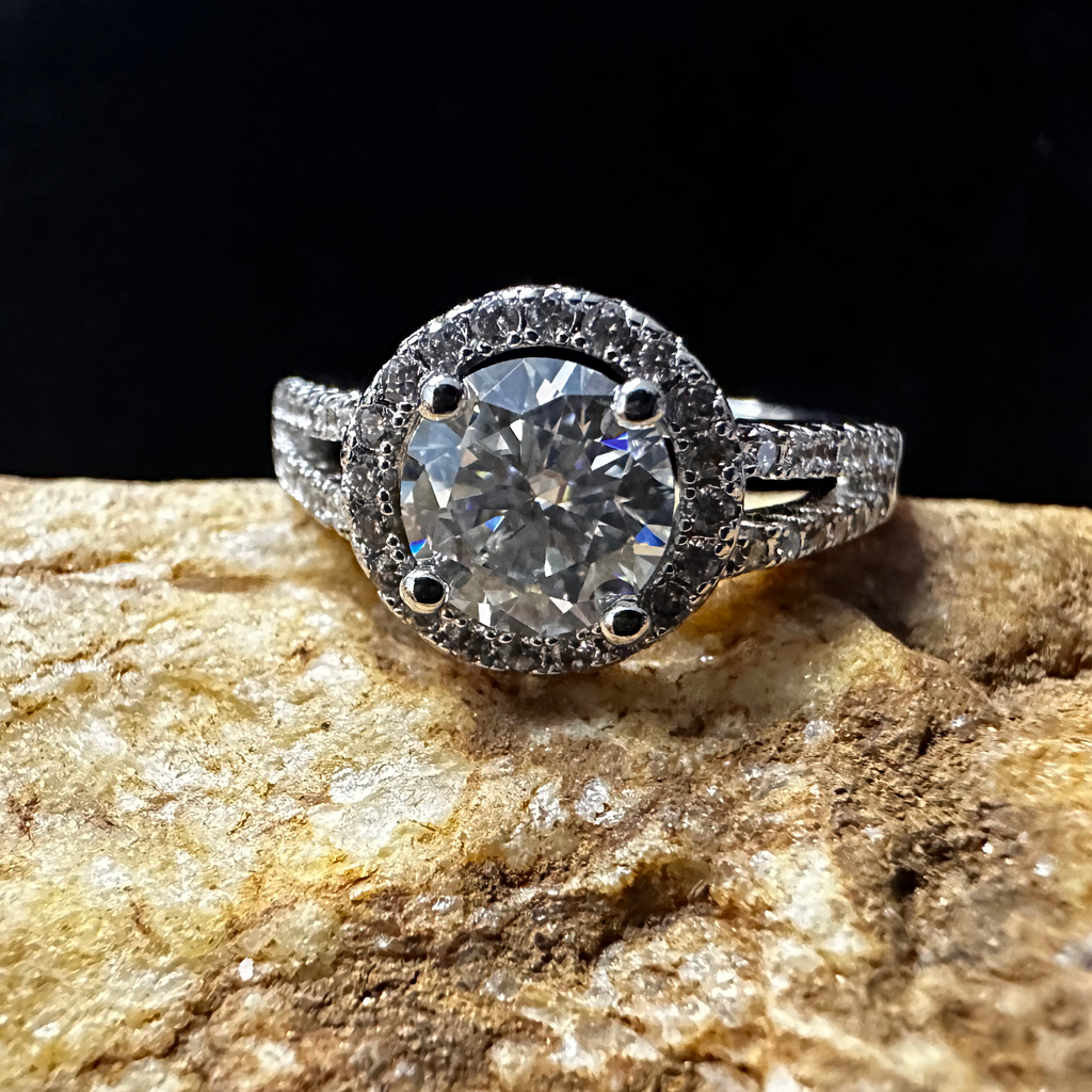 Diamond ring on a textured stone surface with a dark background