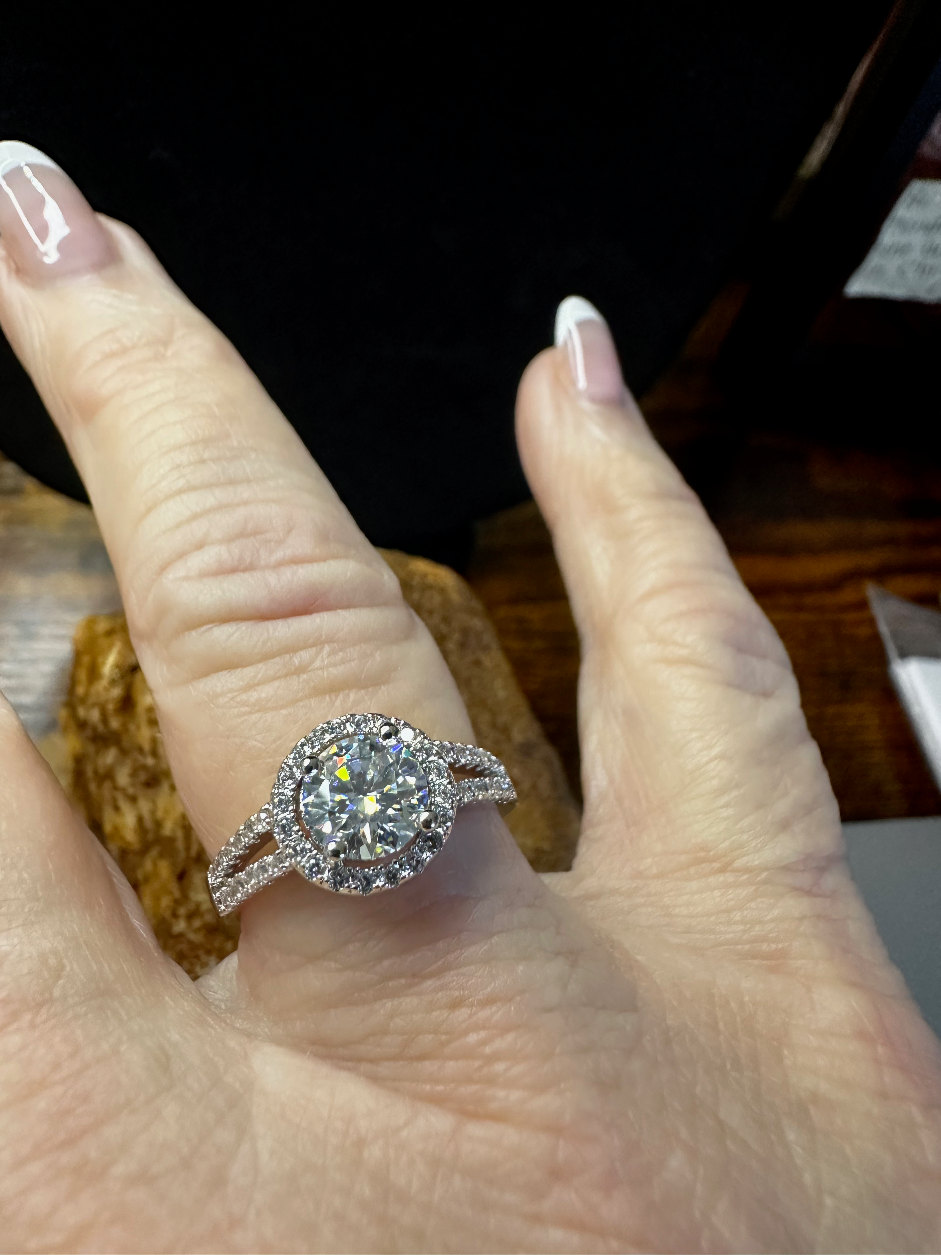 Diamond ring on a finger with a blurred background