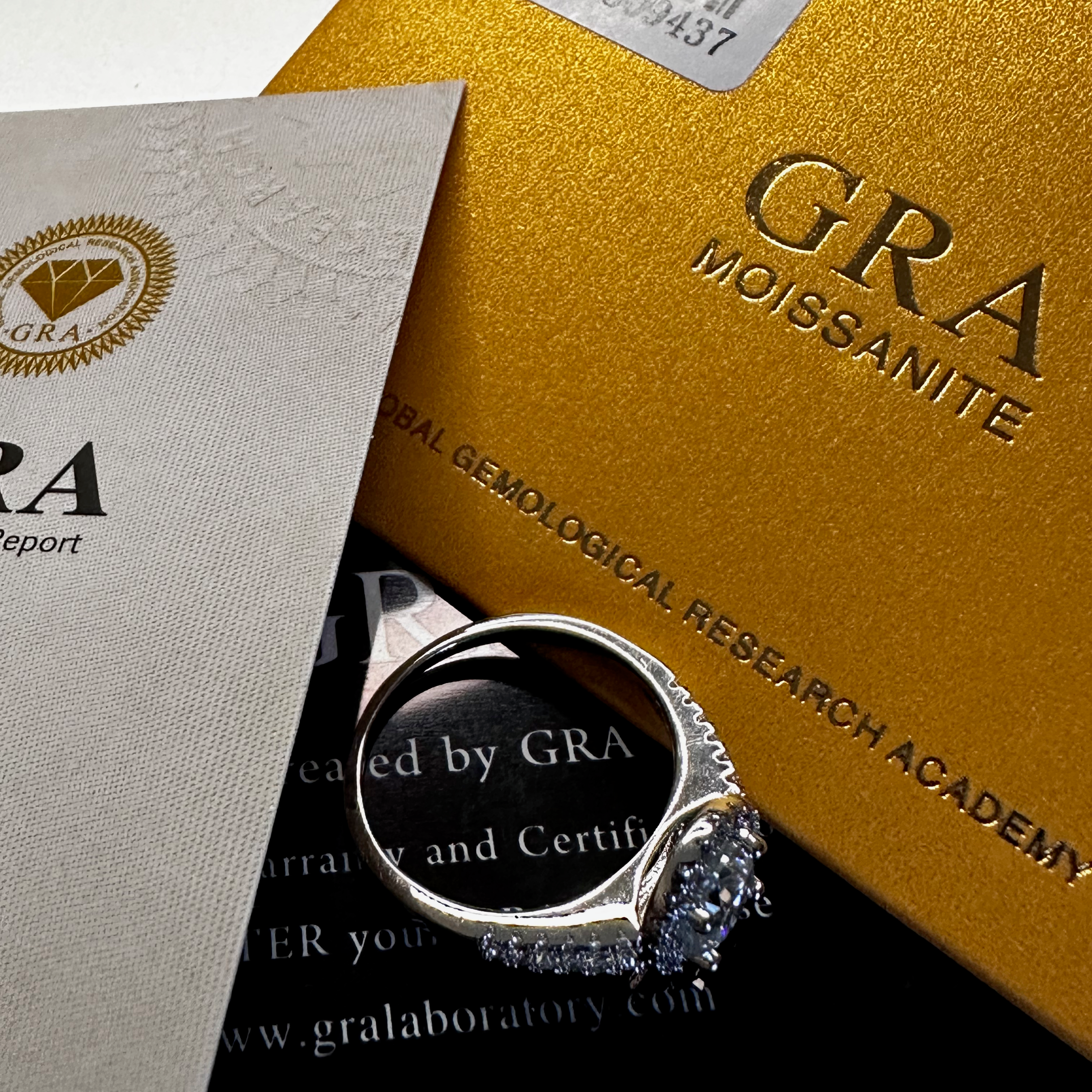 Moissanite ring with GRA (Gemological Research Association) documentation and packaging.