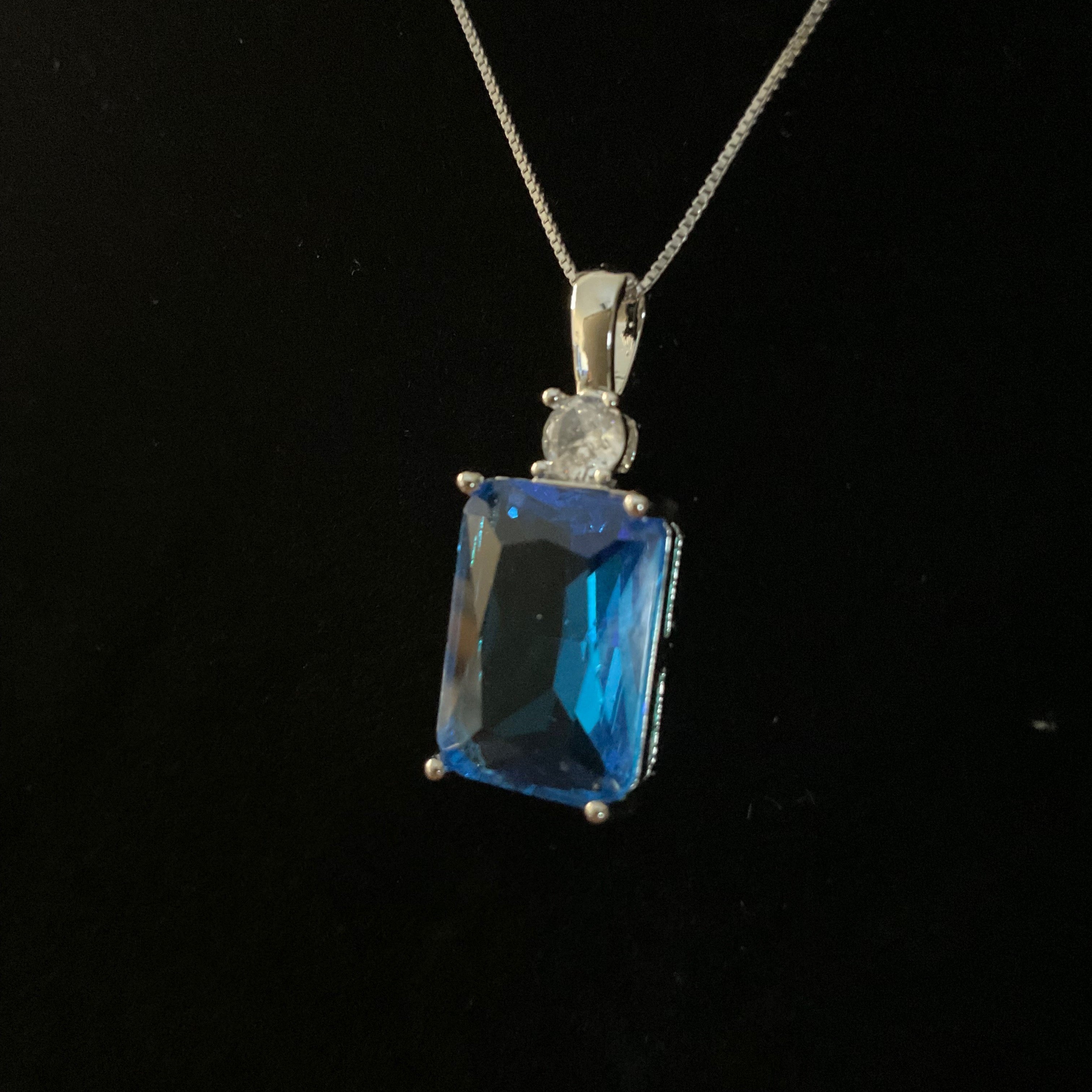 Blue gemstone pendant on a black background