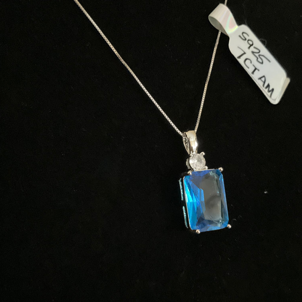 Blue gemstone pendant on a black background