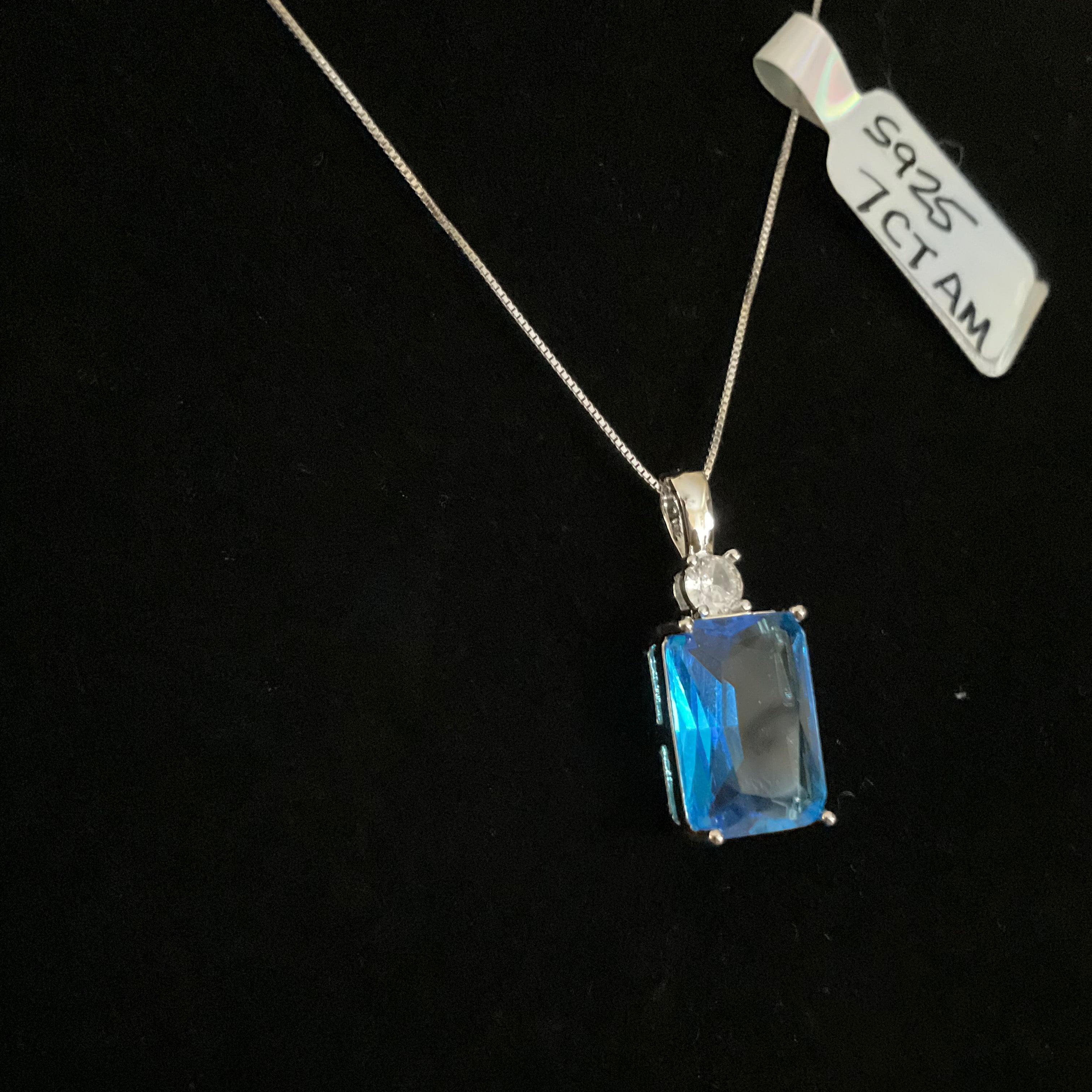 Blue gemstone pendant on a black background