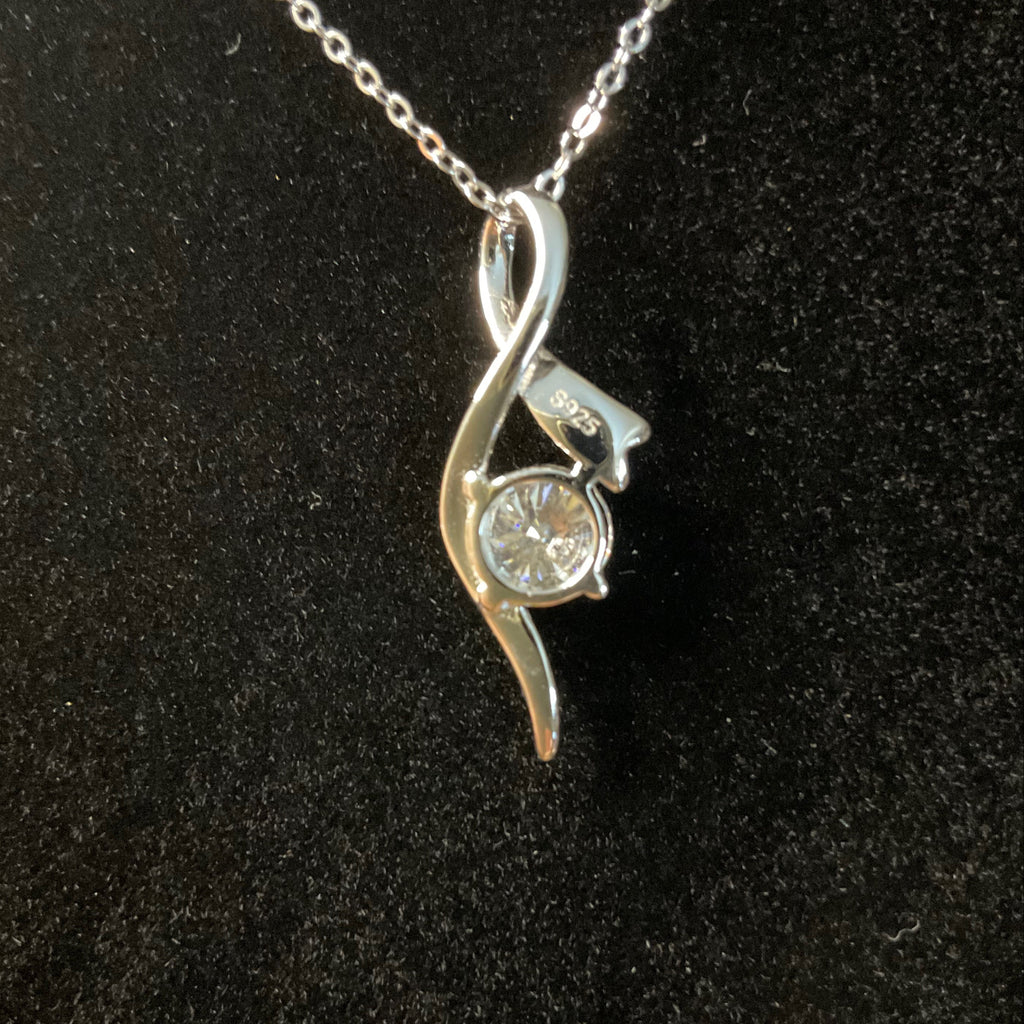 Back of Silver pendant with a diamond on a black background