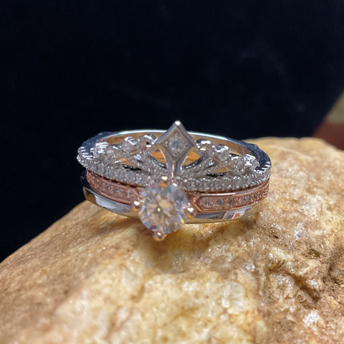 Diamond ring on a rock with a dark background