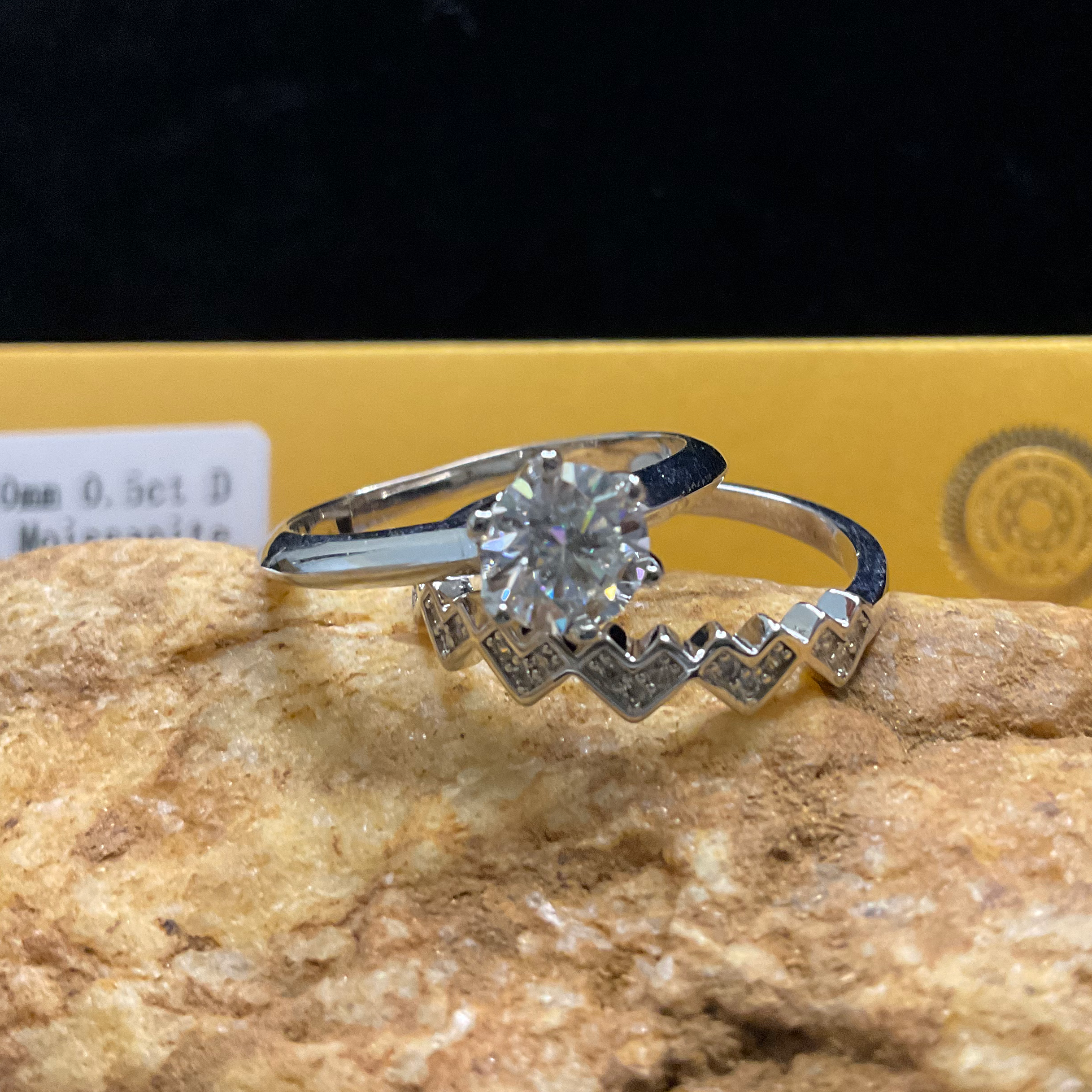 Diamond ring on a rock with a dark background