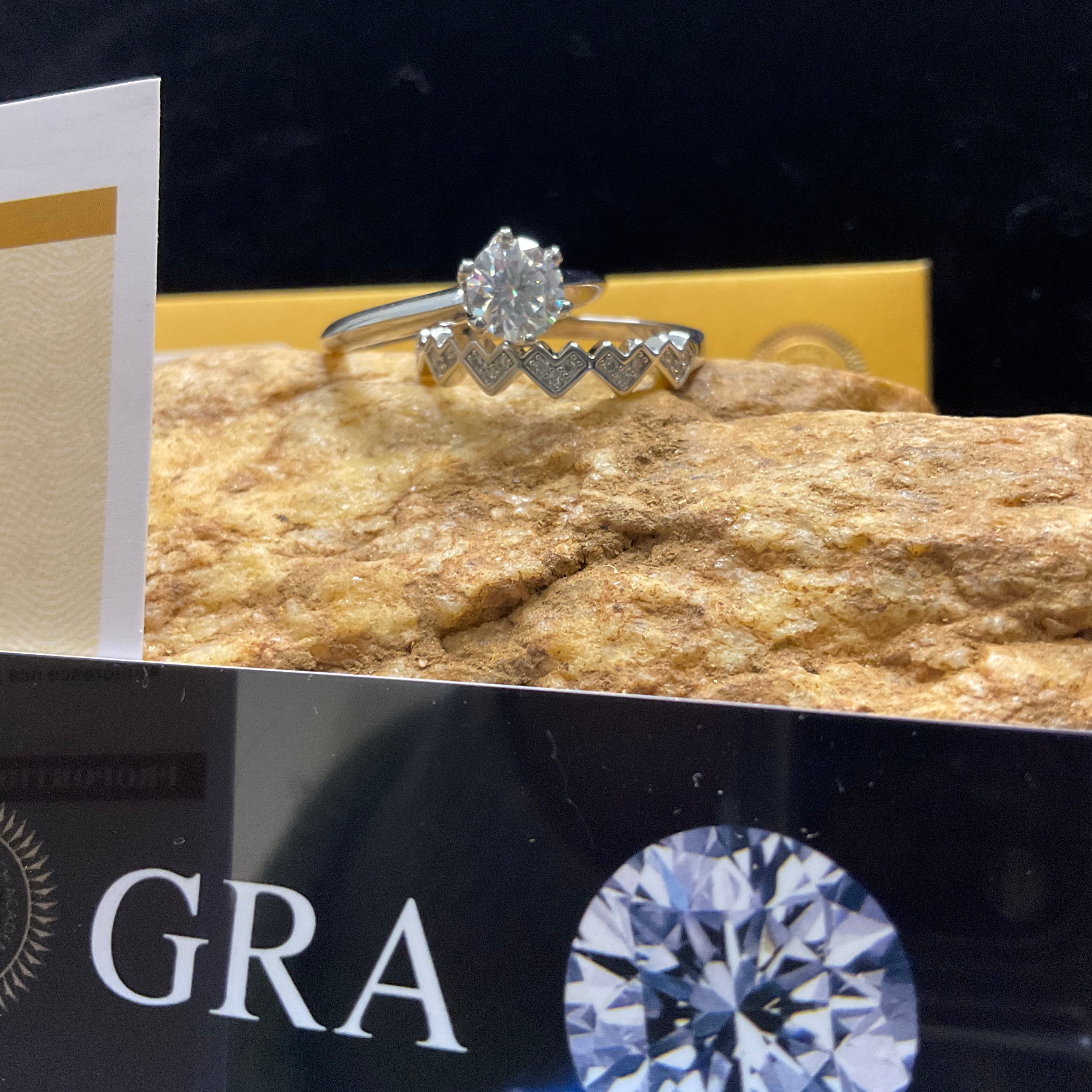 Diamond ring on a rock with GRA branding