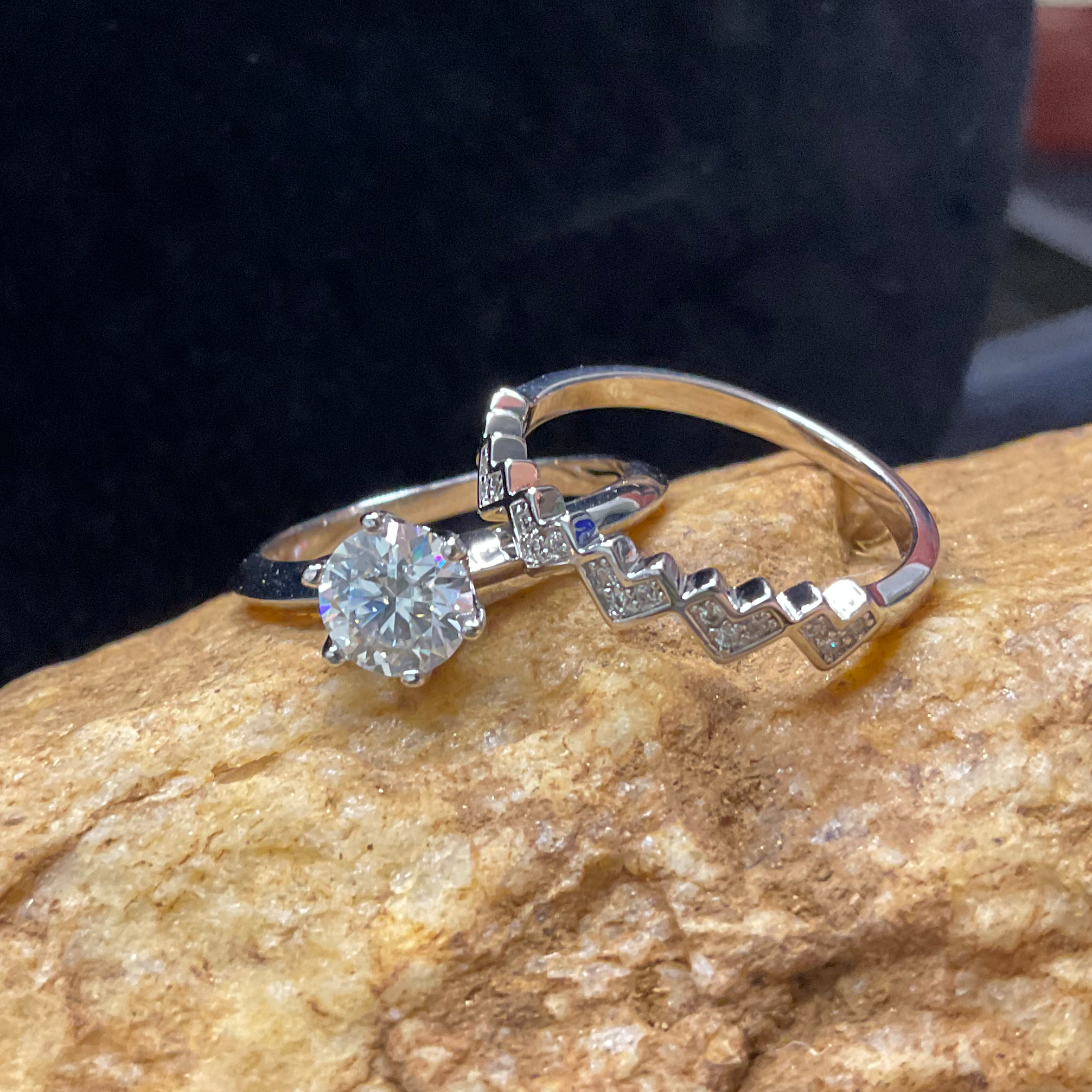 Diamond ring on a rock with a dark background