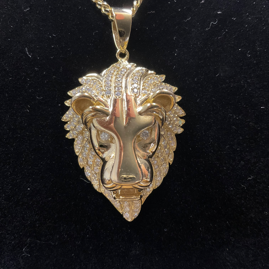 Gold lion head pendant on a black background