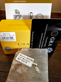 Diamond jewelry with GRA Moissanite packaging on a wooden surface