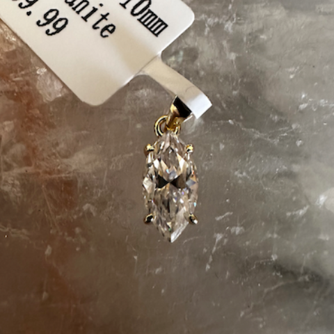 Marquise-shaped moissanite pendant on a crystal background with a price tag.