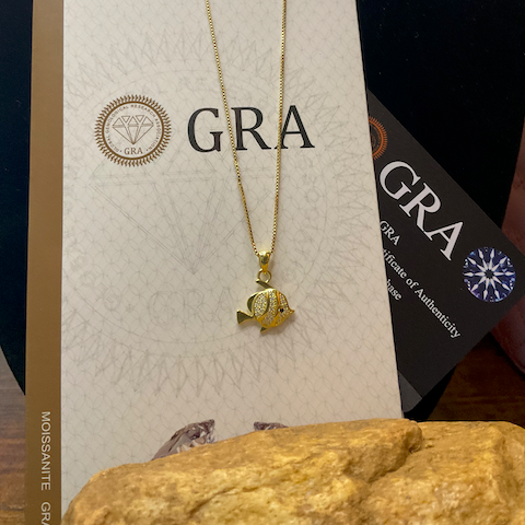 Gold necklace with pendant on a GRA branded card