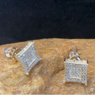 Square-shaped earrings with clear stones on a dark background
