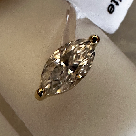 Marquise-shaped diamond on a light gray background