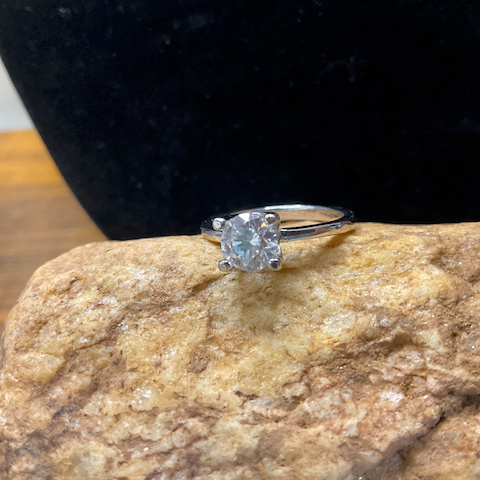 Diamond ring on a rock with a dark background