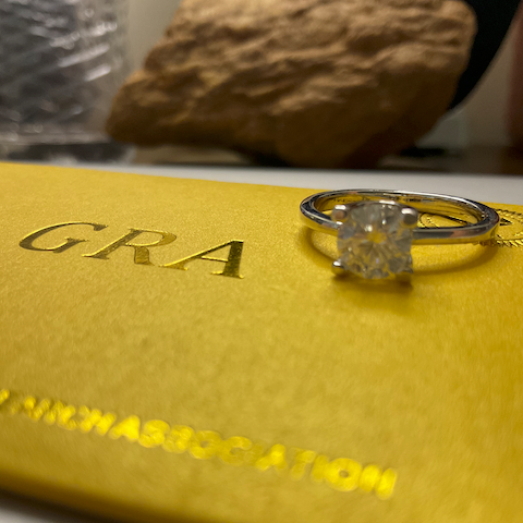 Diamond ring on a yellow box with 'GRA' branding