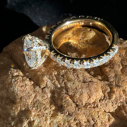 Gold and diamond ring on a textured stone surface