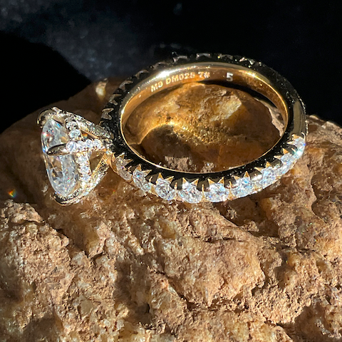 Gold and diamond ring on a textured stone surface