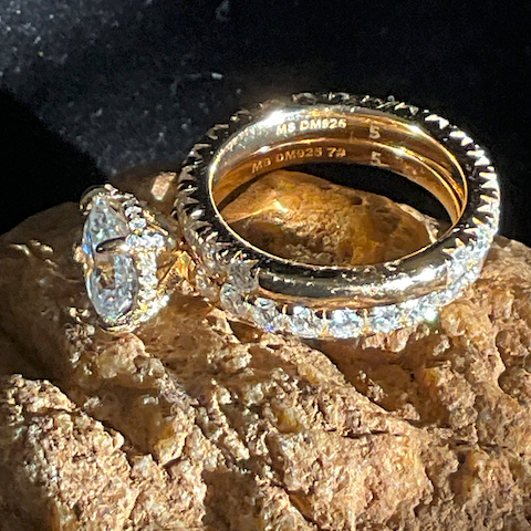 Gold and diamond ring on a textured surface