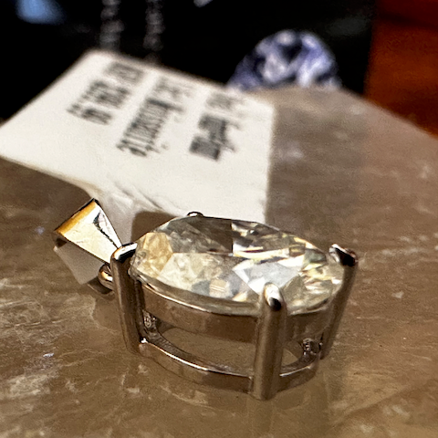 Diamond ring on a metallic surface with a blurred background