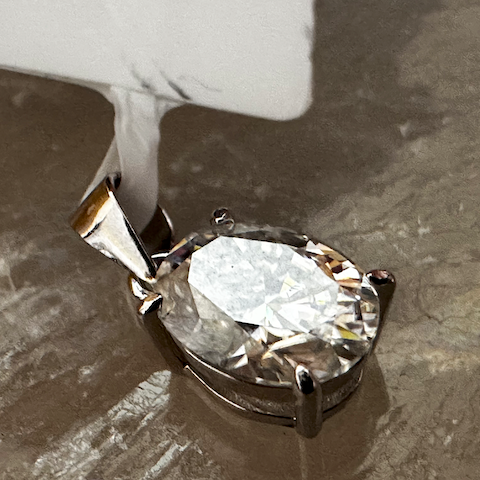 Diamond pendant on a textured surface