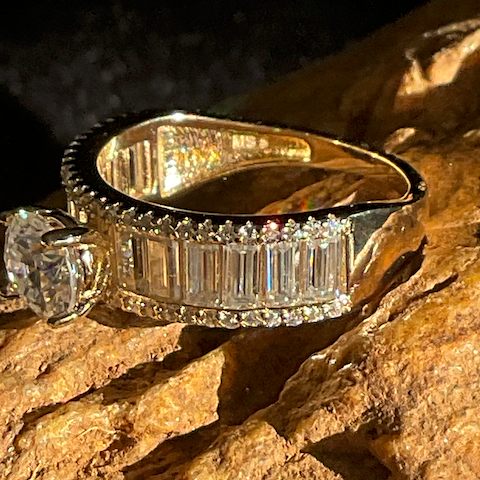 Gold and diamond ring on a textured stone surface