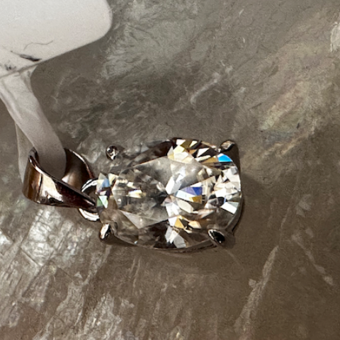Diamond pendant on a textured gray surface