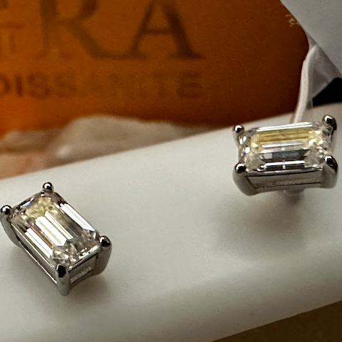 Diamond earrings on a mannequin with a blurred background