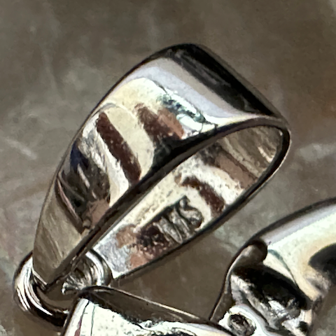 Silver ring on a textured surface