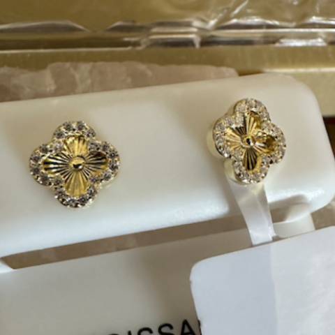 Gold earrings on a Moissaints display card with a clear background