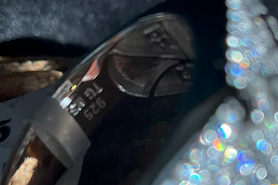 Silver ring with a glittery band on a dark background