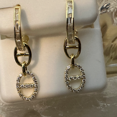 Gold and silver hoop earrings on a mannequin ear