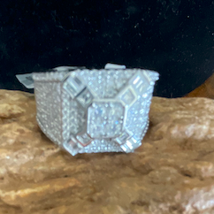 Silver ring on a large rock with a dark background