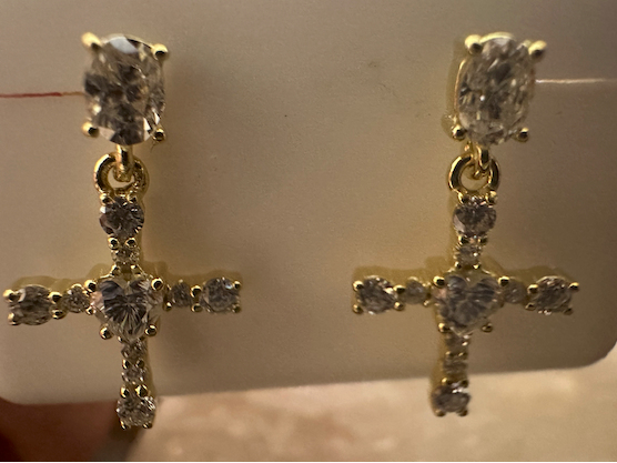 Gold cross earrings with clear stones on a white card