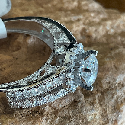 Diamond ring on a stone surface with a tool in the background