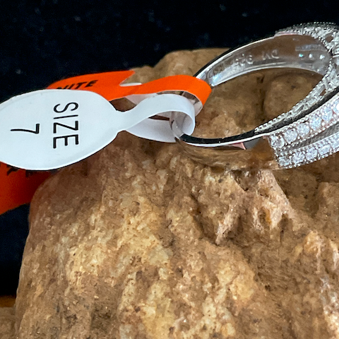 Silver ring with diamond accents on a rock next to a size 7 label.