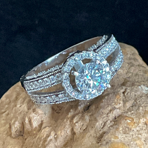 Silver ring with a large diamond on a textured surface