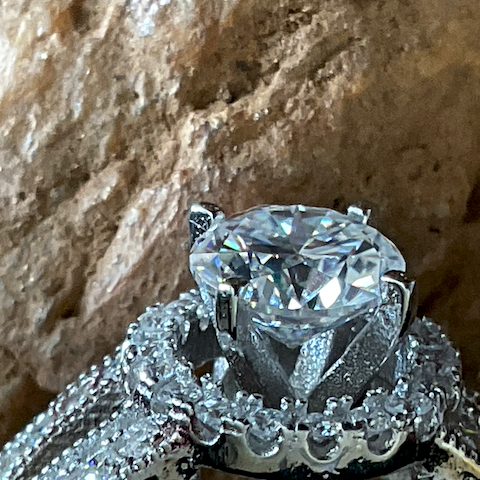 Close-up of a diamond ring on a stone surface
