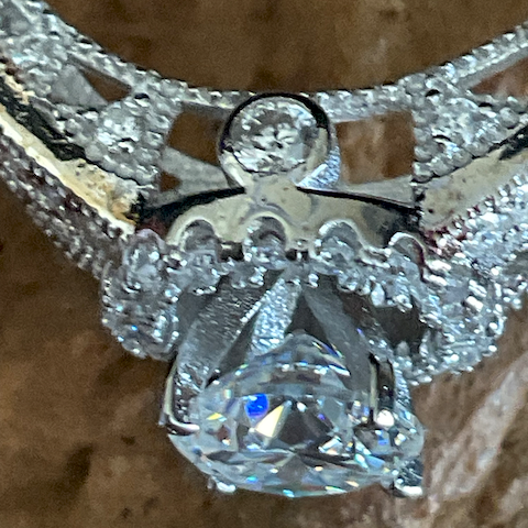 Close-up of a diamond ring with a textured background