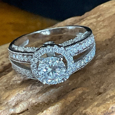 Silver ring with a large diamond on a stone surface