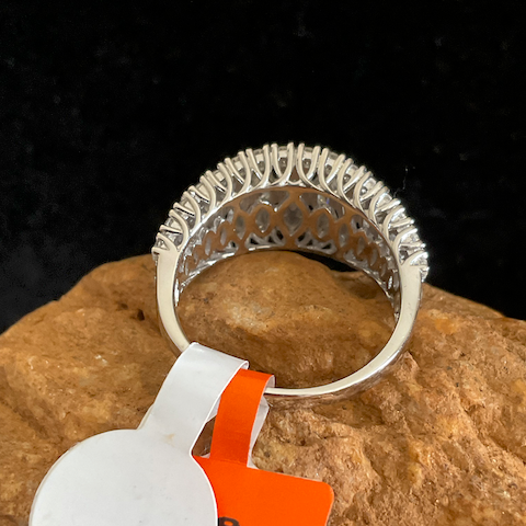 Silver ring on a rock with an orange tag displaying 'MOISSA'.