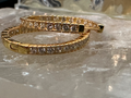 Gold bracelet with diamonds on a reflective surface