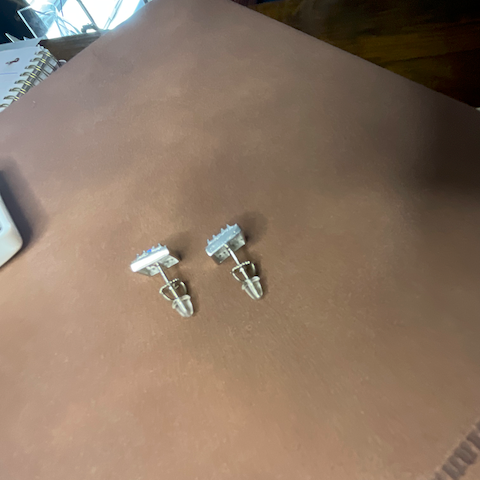 Two small clear plastic objects on a brown surface