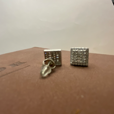 Two small metallic objects on a brown surface