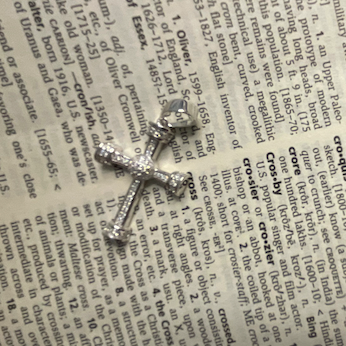 Silver star-shaped object on a textured surface with printed text