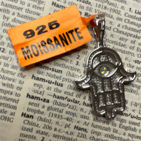 Keychain with orange tag on a printed text background